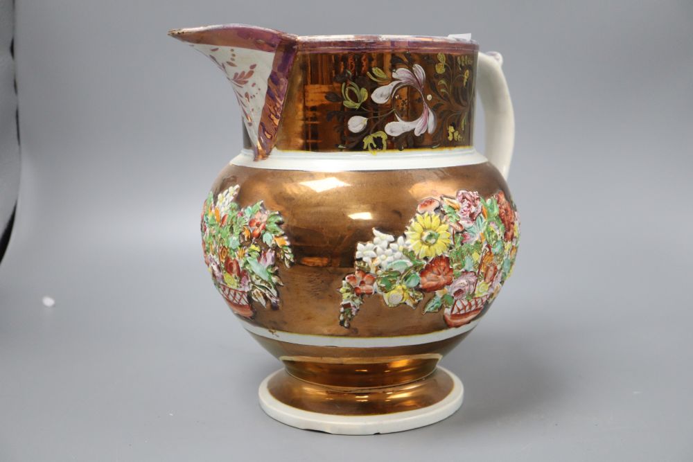 A Victorian pink and copper lustre jug, with moulded floral panels, height 23cm (crack to base)